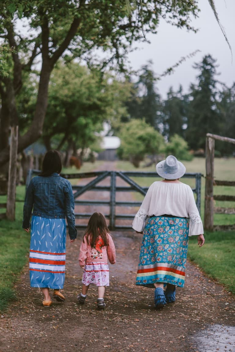 Three generations walking together on a wet track