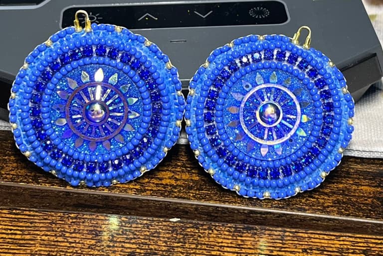 Round beaded earrings in cobalt and royal blue with a shell centre